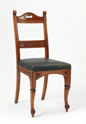  A lacquered mahogany "Spisestuestol" dining chair by G. N. Huseby, with relief carvings on the back slats and legs, and a dark green leather upholstered seat.