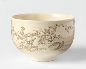  An off-white ceramic bowl with a flared opening, adorned with a sepia-toned pastoral scene featuring detailed foliage and a bird, offering an aesthetic of serene, traditional beauty.