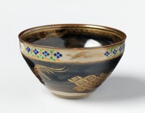  Ceramic bowl with a gradient of brown to beige, featuring a golden rim, horizontal band of blue and green floral motifs, and artistic golden designs against deeper brown towards the bottom, displayed against a neutral background. Artistname and title unknown.