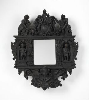  A highly ornate black frame with baroque or rococo motifs, featuring a central rectangular cut-out, decorative swirls, and sculpted figures on its sides, set against a white background. Artist name and title are unknown.