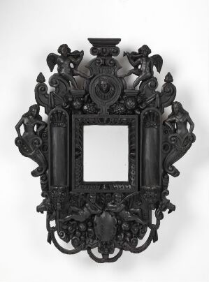  An ornate, symmetrical black frame with a central rectangular void, decorated with intricate floral and scroll motifs, and fantastical creatures, reminiscent of Renaissance or Baroque styles.