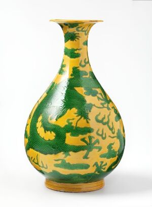  A porcelain vase with a swirling marbled pattern in bright yellow and deep green, showcasing a fluid, organic design with a narrow foot, a rounded body, and a tapering neck that flares at the rim.