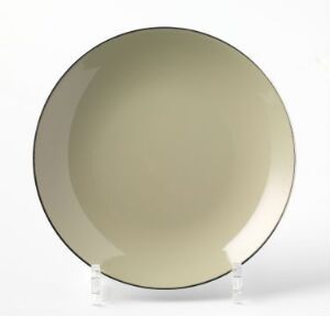  An olive green enameled steel plate with a darker rim and a slight sheen, designed by Cathrineholm, displayed on a clear stand against a neutral white background, reflecting mid-20th century Scandinavian design aesthetics. The title of the piece is unknown.