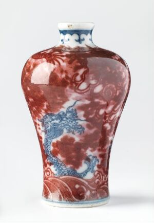  A glossy, red-marbled vase with white swirl patterns and a decorated cobalt blue band around the neck, set against a neutral background.