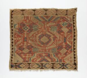  A traditional square textile with a beige background and intricate symmetrical patterns in earth tones, featuring a central diamond motif surrounded by darker red, brown, and green geometric designs, possibly indicating a cultural or antique origin.