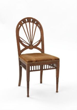  A classical wooden chair with a tan upholstered seat and an oval-shaped backrest featuring a sunburst pattern made of wooden spindles, set against an off-white background.