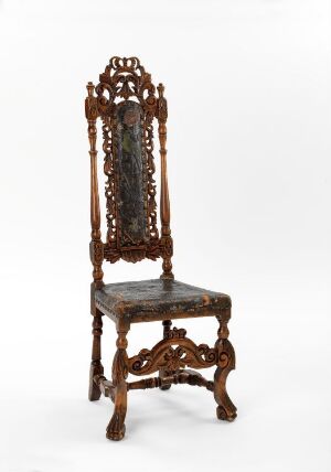  An antique, highly decorative wooden chair with intricate carvings and a tall backrest is set against a neutral background, exuding a sense of traditional elegance.