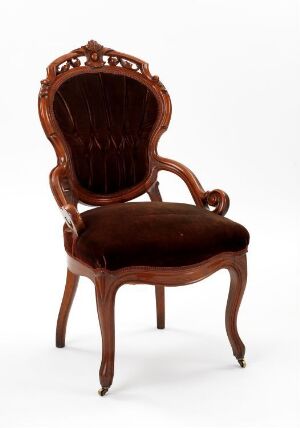  Antique mahogany chair with curved cabriole legs and a detailed shell-like crest on the top of the upholstered backrest, set against a light gradient background.