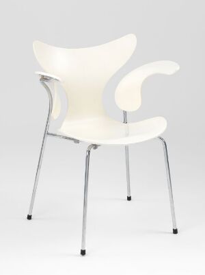  A modern plywood chair with a curved backrest and seat in a creamy color, set against a light gray background with chrome metal legs.