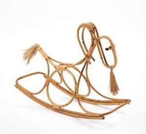  An artistic interpretation of a rocking horse by Sivert Donali, crafted from form-bent, tied, and lacquered manila bamboo. The object is characterized by its abstract skeletal design, with warm brown curves against a white background, conveying a sense of whimsy and modern design.