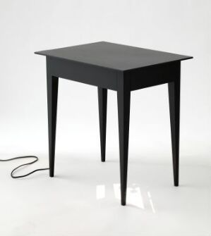  "Subconscious effect of daylight" by Daniel Rybakken - A sleek, matte black table with a soft white glow on its surface, suggesting an internal or external light source, with a cord running off to one side against a white background.