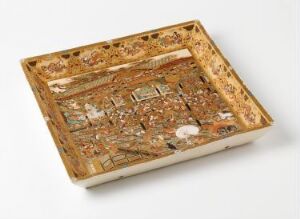  An intricately designed miniature tray depicting a historic market scene with detailed figures and buildings in earthy tones of brown and gold, surrounded by an ornate border with floral motifs.