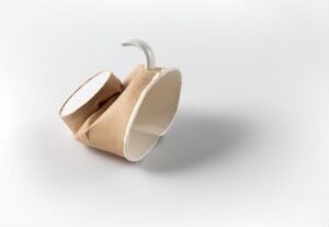  "Street-ware" by Kjell Rylander – an artistic ceramic object crafted to resemble a crumpled paper coffee cup, with a sandy beige body and glossy white rim and handle, placed on a white background, showcasing the creative use of everyday objects in art.