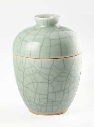  A gently curved celadon green ceramic vase with fine crackle patterns and a gold band around the center against a white background. Artistname and title are unknown.