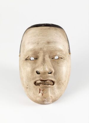  A traditional Japanese Noh mask, carved from wood and painted in subtle, muted tones. The mask has a neutral expression with slightly downcast, almost closed eyes, and a closed mouth with downturned corners, against a plain background. Artist name unknown, title "Noh-maske".