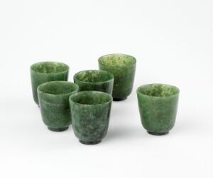  A collection of six irregularly shaped green cups with a marbled effect, displayed on a light gray background.