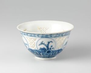  An antique Chinese porcelain bowl with blue and white decoration, featuring floral and geometric patterns, displayed against a light grey background.