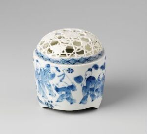  A small round ceramic box with a reticulated lid, featuring classic blue floral patterns on a white background, suggestive of traditional porcelain craftsmanship.