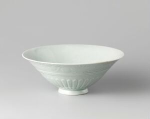  A muted white ceramic bowl with vertical grooves on the exterior, placed on a light gray background.