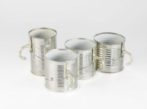  A set of four tin mugs with horizontal ridges and cast tin handles, created by Hans Stofer, titled "Tin Mugs", delineating a functional art piece in a monochromatic metallic color scheme against a neutral background.