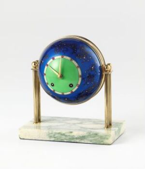  An aesthetically designed ornamental clock with a round, deep blue case featuring a star-like speckled pattern, a mint green face with black hands, mounted on golden-colored supports, and resting on a rectangular white and grey marbled base.