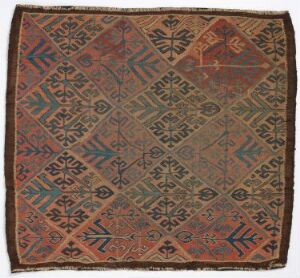  Antique square textile with intricate symmetrical geometric patterns in earthy tones of terracotta, indigo, teal, dusty rose, and mustard, featuring a central diamond motif radiating outwards to an octagonal perimeter with slightly frayed edges.