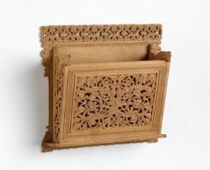  An intricate wooden carved stand with two tiers, featuring detailed floral and geometric patterns with openwork lattice design, set against a neutral background.