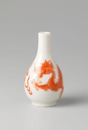  A slender white ceramic vase with a dynamic splash of orange color artistically smeared on one side, displayed against a plain light gray background. The artist's name and the title of the piece are unknown.