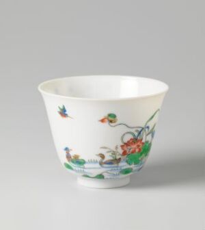  A porceline bowl with hand-painted colorful birds and floral designs on a white background against a neutral gray surface. Artist name and title are unknown.