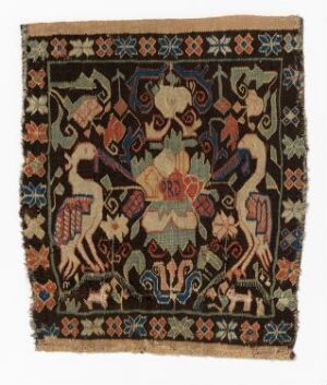  A square tapestry with a dark brown background, featuring a central symmetrical floral design in soft pink, green, and cream, surrounded by symmetrical animal figures that resemble horses in a tan color with dark brown patterns, and a border of geometric and floral motifs in beige