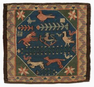  A square folk art textile with a navy blue background and a light tan border featuring red and green star-like motifs. The piece