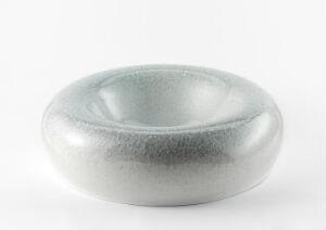  "Melert form" by Gunnar Thorsen, a shallow, round, glazed stoneware bowl with a gradation of soft white to speckled, dark gray centered on a white background.