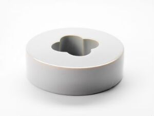  "Omkranset form," by Gunnar Thorsen - a minimalist glazed and cast stoneware piece with a serene gray hue and a narrow peach-toned band, designed as a short cylindrical shape with a central hollow void on a pure white background.