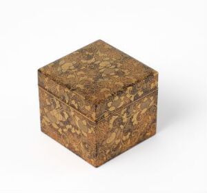 
 A decorative cube-shaped box with a marbled pattern in warm brown tones on a gradient white to light grey background.