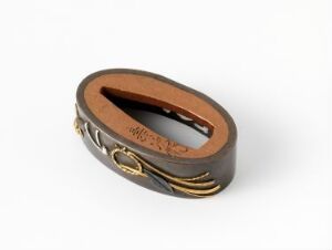  An oval-shaped, dark chocolate brown leather bracelet with gold and brass-colored metal decorative elements, against a white background. The inside of the bracelet is tan.