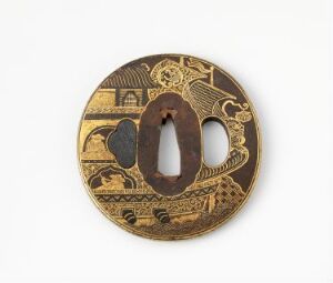  A circular Japanese sword guard, known as a tsuba, with a central oval-shaped opening and intricately detailed golden patterns on a dark brown background, suggesting traditional craftsmanship and ornamental design.