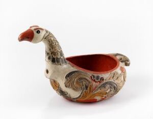  A ceramic container in the shape of a stylized bird, with a white and red color scheme and decorative patterns on its sides, placed against a white background.