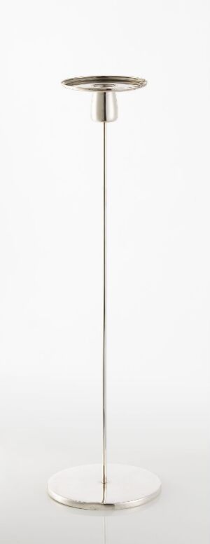  A modern, slender, floor-standing lamp with a circular base, a thin vertical pole, and a wide, circular top, all with a glossy metallic finish against a white background.