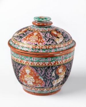  "Bencharong" (title) - A vibrantly decorated porcelain pot with a lid by an unknown artist, featuring rich oranges, greens, blues, and gold enamels in floral and mythical patterns on a white base.