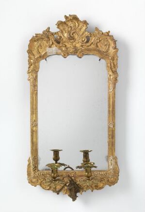  An ornate golden-framed antique mirror with integrated candle sconces, featuring intricate baroque-style carvings.