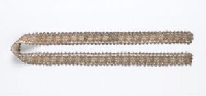  A finely crafted strip of jewelry with closely set round beads or crystals in shades of champagne and translucent beige, displayed on a light grey background, showcasing a luxurious and elegant design. Artistname and title are unknown.