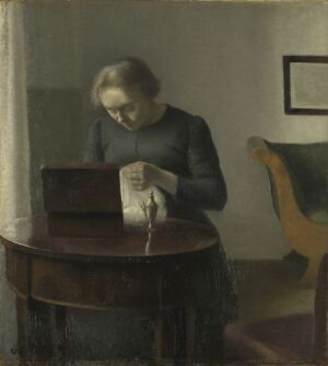  An oil painting on canvas by Vilhelm Hammershøi depicting a woman reading a letter at a wooden table in a dimly lit room with a muted color palette, creating an atmosphere of quiet introspection.