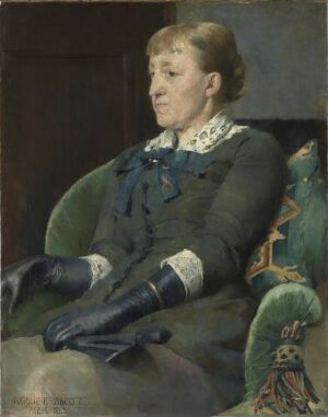  Oil on canvas painting by Harriet Backer titled "The Artist Kitty Kielland" displaying a calm, middle-aged woman in a dark teal-blue jacket with white lace details, sitting in an ornate, floral-patterned green armchair, her thoughtful gaze directed away from the viewer. The figure is set against a dark, muted background that emphasizes her presence in the soft, ambient light.