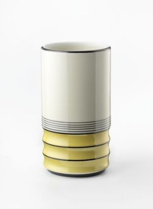  A porcelain cylindrical vase titled "Modell 2110" by Nora Gulbrandsen, featuring an off-white upper body with two thin horizontal lines and a ribbed lower base with glossy yellow bands.