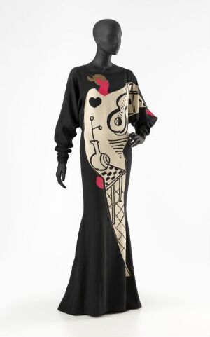  "Nuit dessinée nr 10" by Per Spook - A mannequin wearing a sophisticated, predominantly black silk evening gown with an asymmetrically positioned, whimsical cream and red abstract design, set against a neutral light grey background.