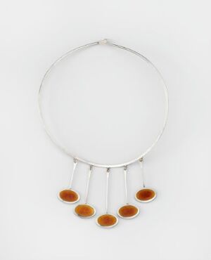  A silver necklace with a rigid circular band and five equally spaced amber-colored oval pendants, against a white background.