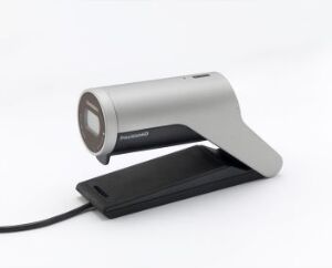  The Tandberg PrecisionHD USB Camera by Tandberg design, featuring a sleek metallic silver cylindrical lens housing with a dark front ring, mounted on an elegantly curved stand and a matte black rectangular base, against a neutral gray background.