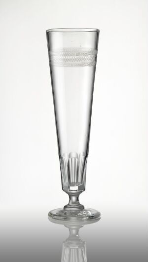  A faceted and etched crystal champagne flute by an unknown artist, showcasing a blend of smooth and geometrically cut surfaces that reflect light intricately.