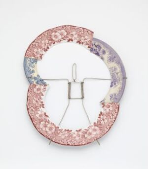  An artisan object by Kjell Rylander, "Uten tittel", featuring a circular earthenware form segmented into four parts, with each quarter decorated in different colors and vintage floral patterns, held together in the center by a metallic mounting system, against a white background.