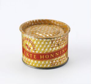  "Ekte honning" pressed and lithographed steel honey container designed by Norges Birøkterlag, featuring a golden honeycomb pattern, a prominent red band with the product name in yellow, and additional decorative white and gold accents.